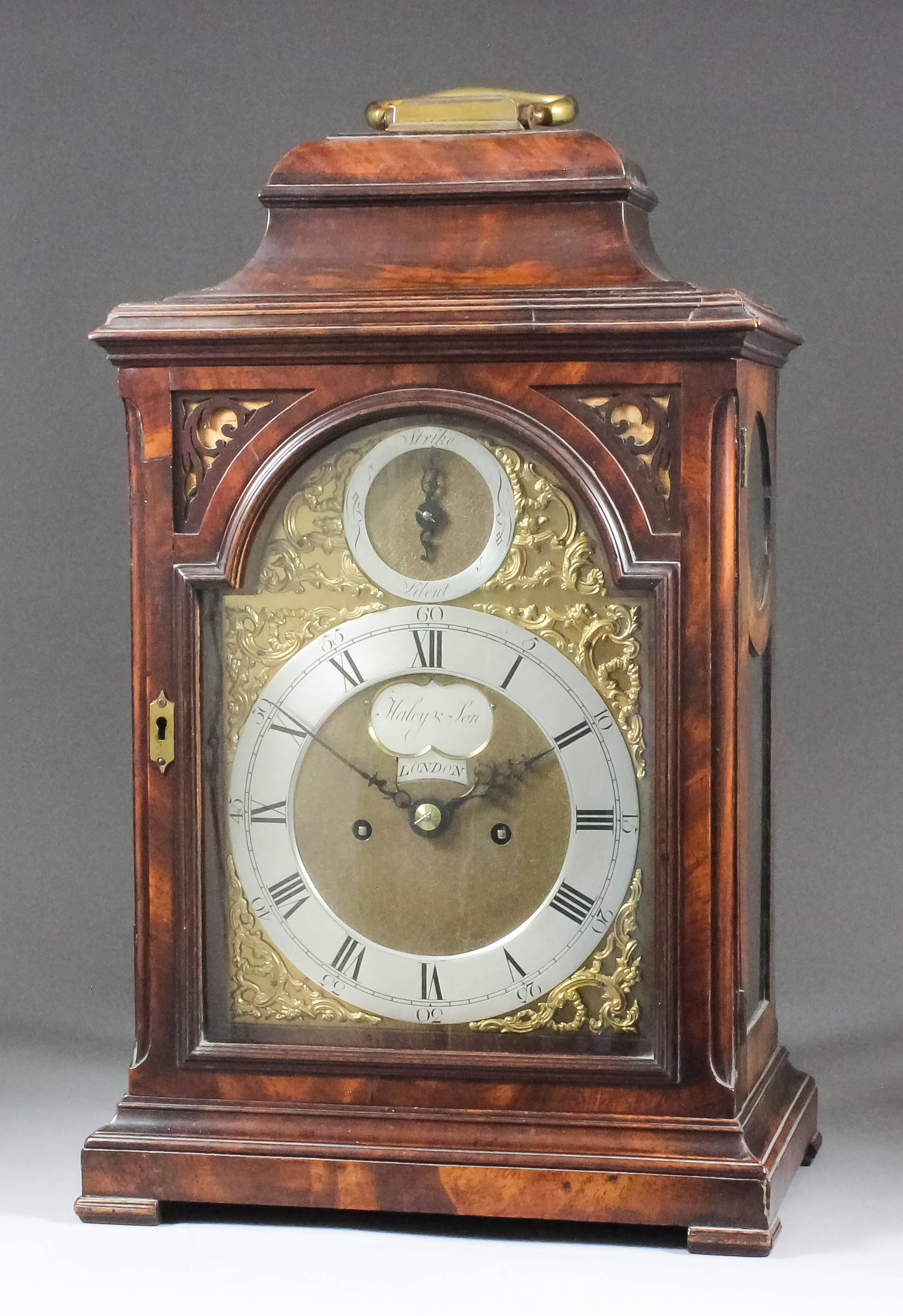 An early George III mahogany table clock by Haley & Son of London, the 7ins arched brass dial with