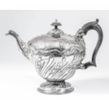 An early George III silver circular teapot of slight baluster shape, the part spiral reeded and