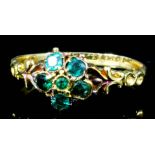 An 18ct gold mounted and emerald ring, set with six small stones in flowerhead pattern (size O -