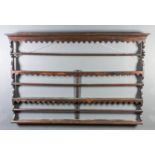 An 18th Century oak Delft rack with moulded cornice and shaped frieze and aprons, on shaped sides