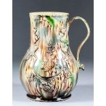 An 18th Century creamware pottery tankard with Whieldon type glaze moulded with flowers, 7.25ins