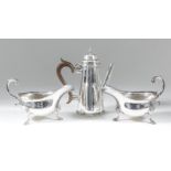 A pair of Edward VII silver oval sauce boats with shaped rims and leaf capped double C-scroll