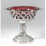 A Victorian silver circular tazza, the shaped and moulded rim cast with floral sprays and ribbons,