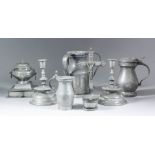 A collection of pewter domestic wares, including - a pair of Continental candlesticks after late