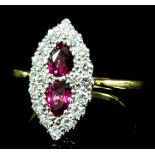 A modern 18ct gold ruby and diamond marquise ring, set with two tear drop rubies (approximate