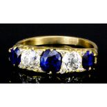 A modern 18ct gold mounted sapphire and diamond five stone ring, set with three oval cut