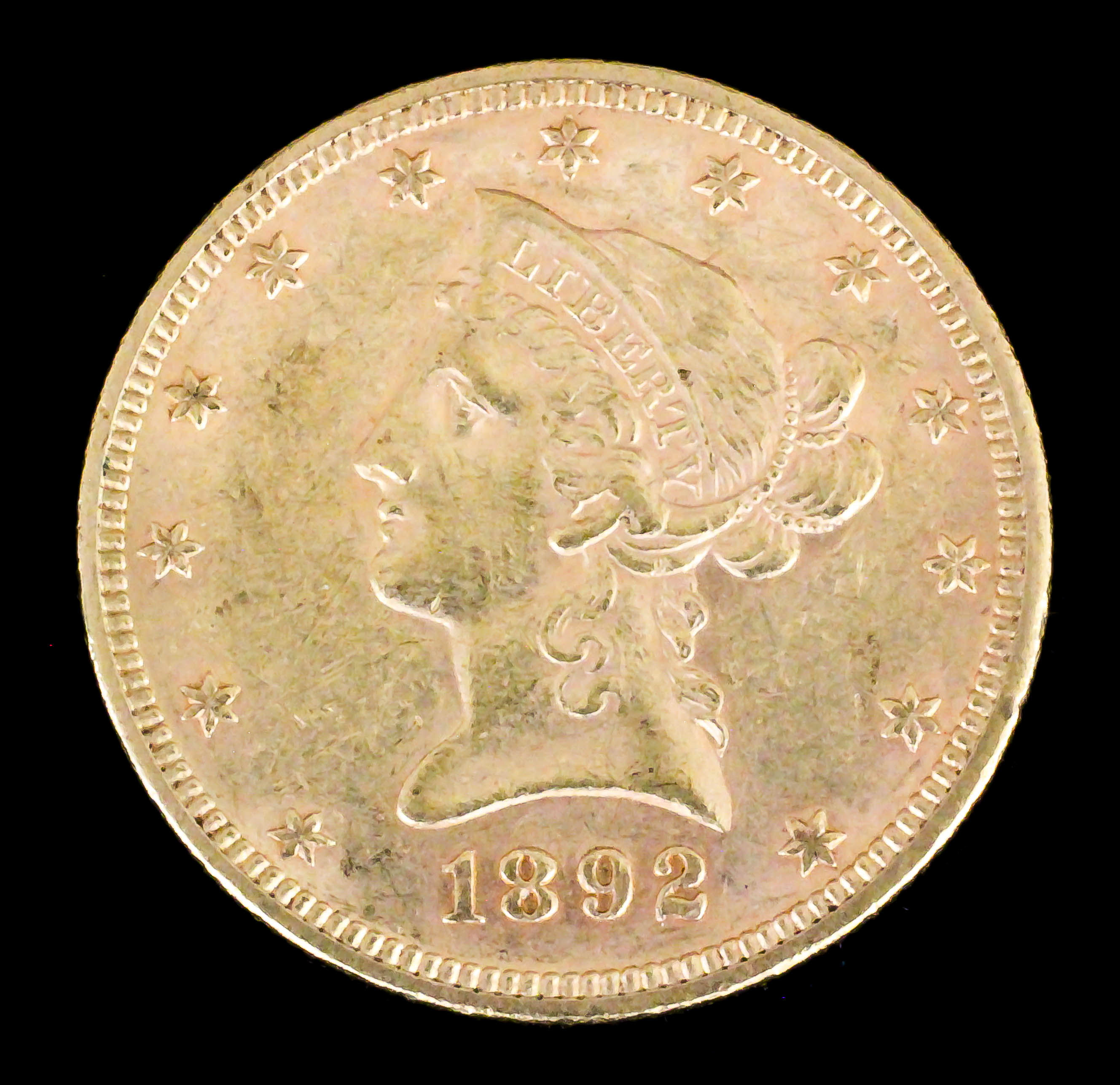 A USA 1892 gold Coronet Eagle (weight 16.7 grammes - fair/fine with slight scuff marks)