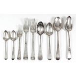 Four Georgian silver table spoons, a selection of silver dessert spoons, tea spoons and table forks,