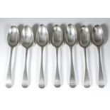 Seven George III silver feather edged table spoons, hallmarks either rubbed or partially struck, (
