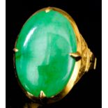 A modern gold coloured metal mounted jade ring, set with cabochon oval jade stone, 23mm x 17mm, with