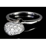 A modern Cartier 18ct white gold mounted and diamond ring, hung with heart shaped charm pave set