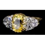 An 18ct gold mounted yellow sapphire and diamond ring, set with central oval yellow sapphire (