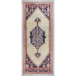 A Serouk long rug with bold central pole medallion filled with stylised flowerheads and leaf design,