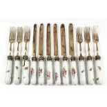 A set of six Continental gilt metal and porcelain handled fruit knives and forks, the handles