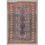 A Kazak rug woven in colours with central four section pole medallion, filled with angular and