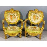 A pair of 20th Century Continental gilt open arm easy chairs in the French manner, with bold