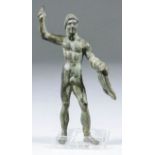 A Roman bronze figure of Herakles with the Nemean lion skin draped over his left arm, his raised