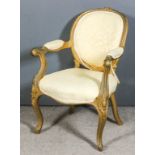 A French gilt framed open arm easy chair of "Louis XV" design with oval back, the seat and armpads