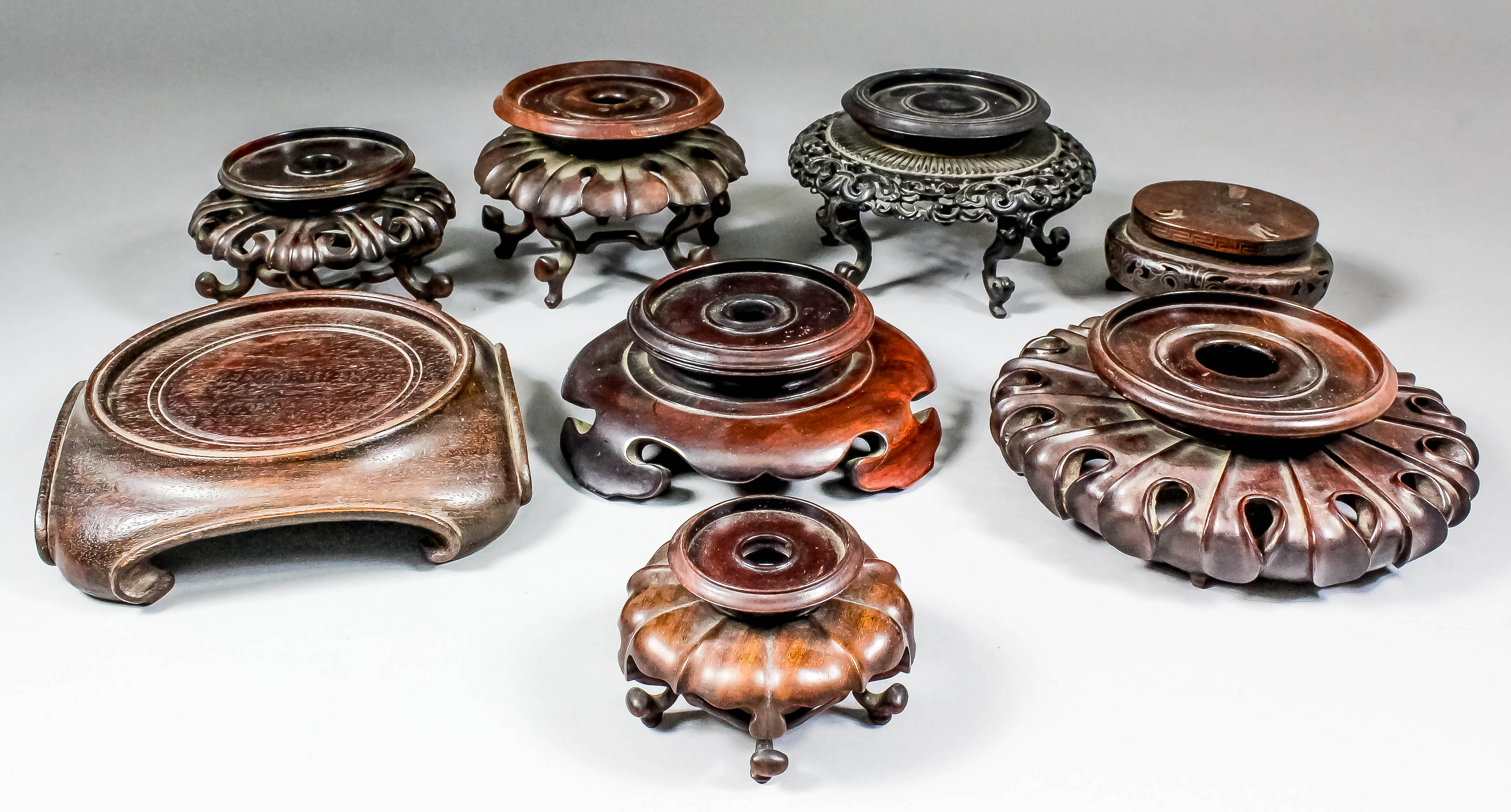 A collection of thirty Chinese carved, pierced and turned hardwood vase and bowl stands, various