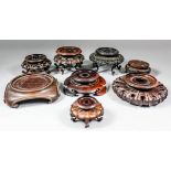 A collection of thirty Chinese carved, pierced and turned hardwood vase and bowl stands, various