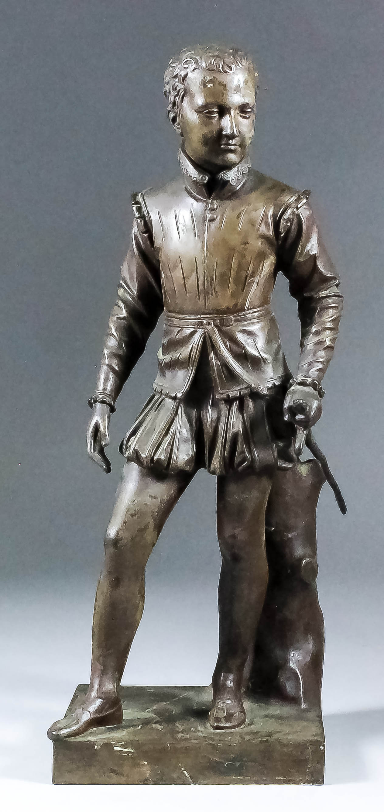 19th Century French school - Brown patinated bronze figure of a young man wearing doublet and