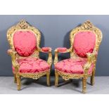 A pair of French gilt framed fauteuil of "Louis XV" design, the shaped backs with fretted and carved