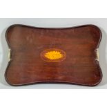 An early 20th Century mahogany two-handle tray with incurved sides, the centre with shell inlay,