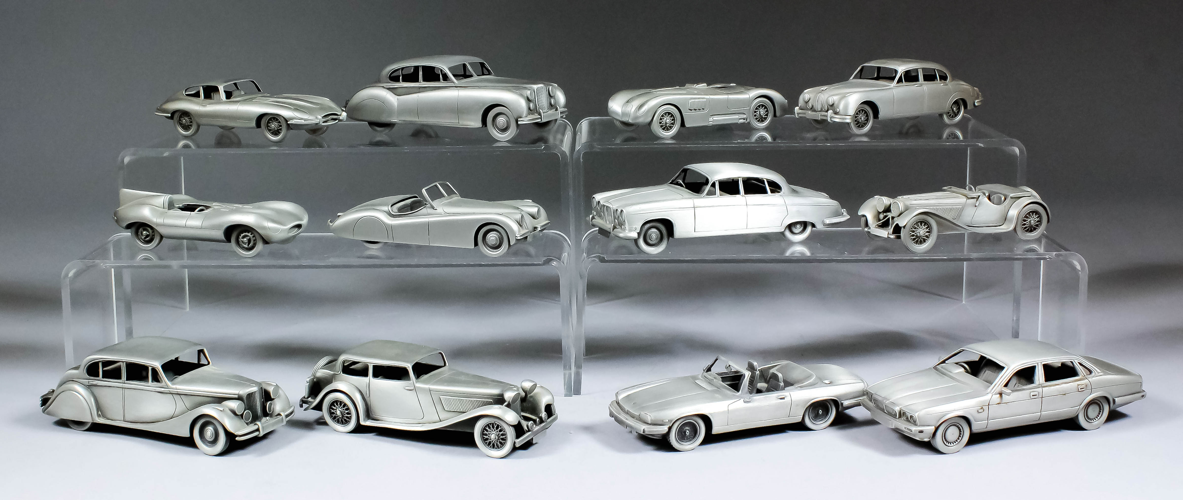 A collection of twelve Danbury Mint pewter replicas of classic Jaguar cars, in original packaging