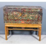 A Chinese leather covered wooden coffer of plank construction, the lid painted with a head of a