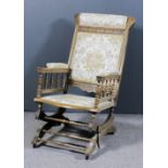 A late 19th/early 20th Century American stripped wood rocking chair, the rectangular back with