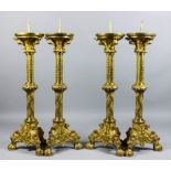 A set of four 19th Century Continental gilt brass pricket candlesticks, the wide sconces supported