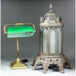 A late Victorian cast iron octagonal oil stove with pinnacle top inset with frosted glass panels, on