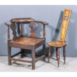 An 18th Century provincial oak corner chair of "Country Chippendale" design with horseshoe pattern