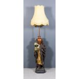 A Victorian painted pottery cast iron and copper standard lamp in the form of a standing Arab