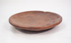 NATURALISTIC LARGE WOODEN FOOD BOWL, having flat rim, good patination, 28 1/2" (72.5cm) diameter