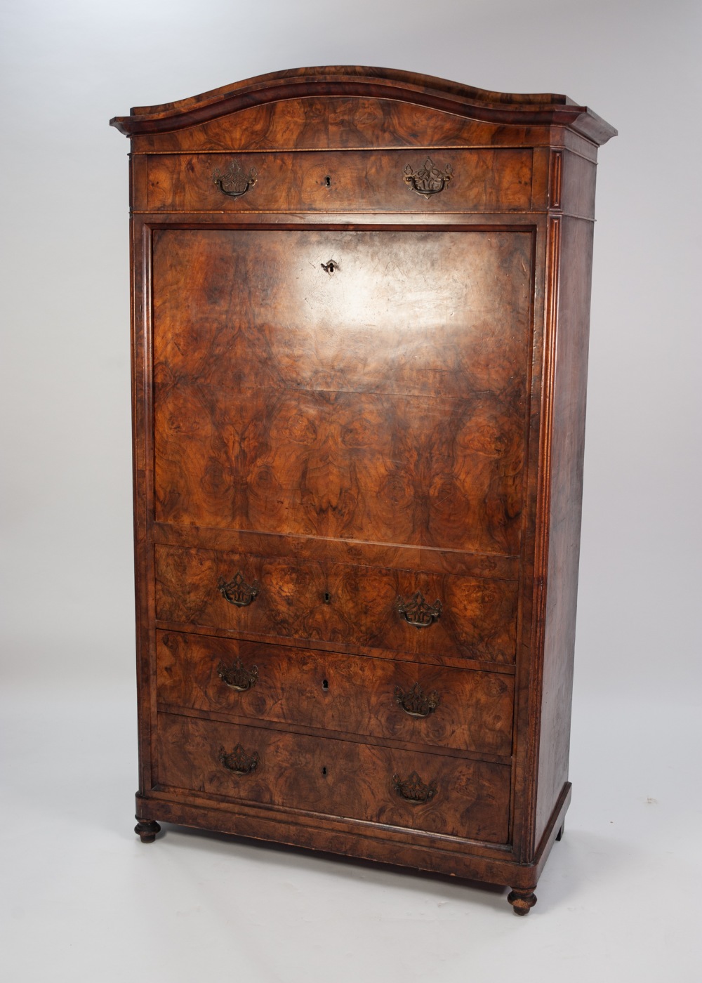 A LATE NINETEENTH CONTINENTAL FIGURED WALNUTWOOD VENEERED SECRETAIRE A' ABATTANT with two arched