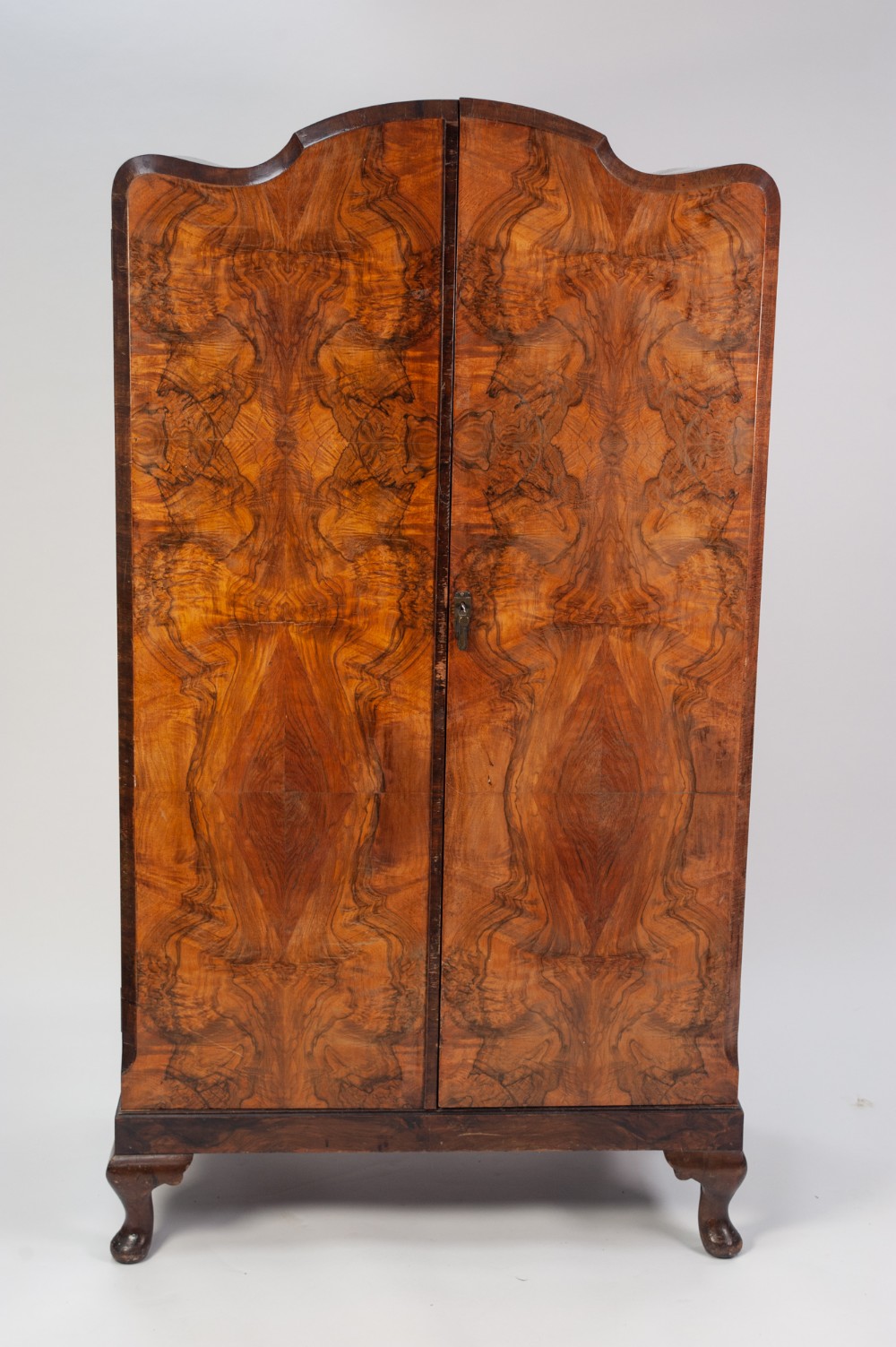 a 1930's WALNUTWOOD GENTLEMAN'S TWO DOOR WARDROBE on short cabriole legs