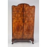 a 1930's WALNUTWOOD GENTLEMAN'S TWO DOOR WARDROBE on short cabriole legs