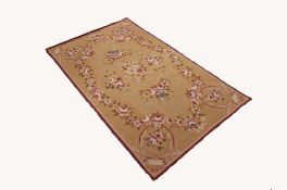 FRENCH TAPESTRY RUG, with an oval centre medallion on roses, rose border and spandrels, on buff