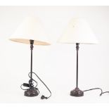 MODERN PAIR OF BLACK JAPPANNED METAL TABLE LAMPS, each with embossed circular bases and cloth shade,