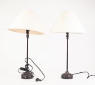 MODERN PAIR OF BLACK JAPPANNED METAL TABLE LAMPS, each with embossed circular bases and cloth shade,