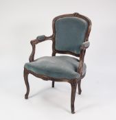 A TWENTIETH CENTURY FRENCH BEECHWOOD OPEN ARM FAUTEUIE, covered in blue velour