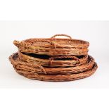 PAIR OF CIRCULAR TWO HANDLED WICKER BREAD TRAYS, 22" (56cm) diameter, and a MATCHING SET OF THREE,