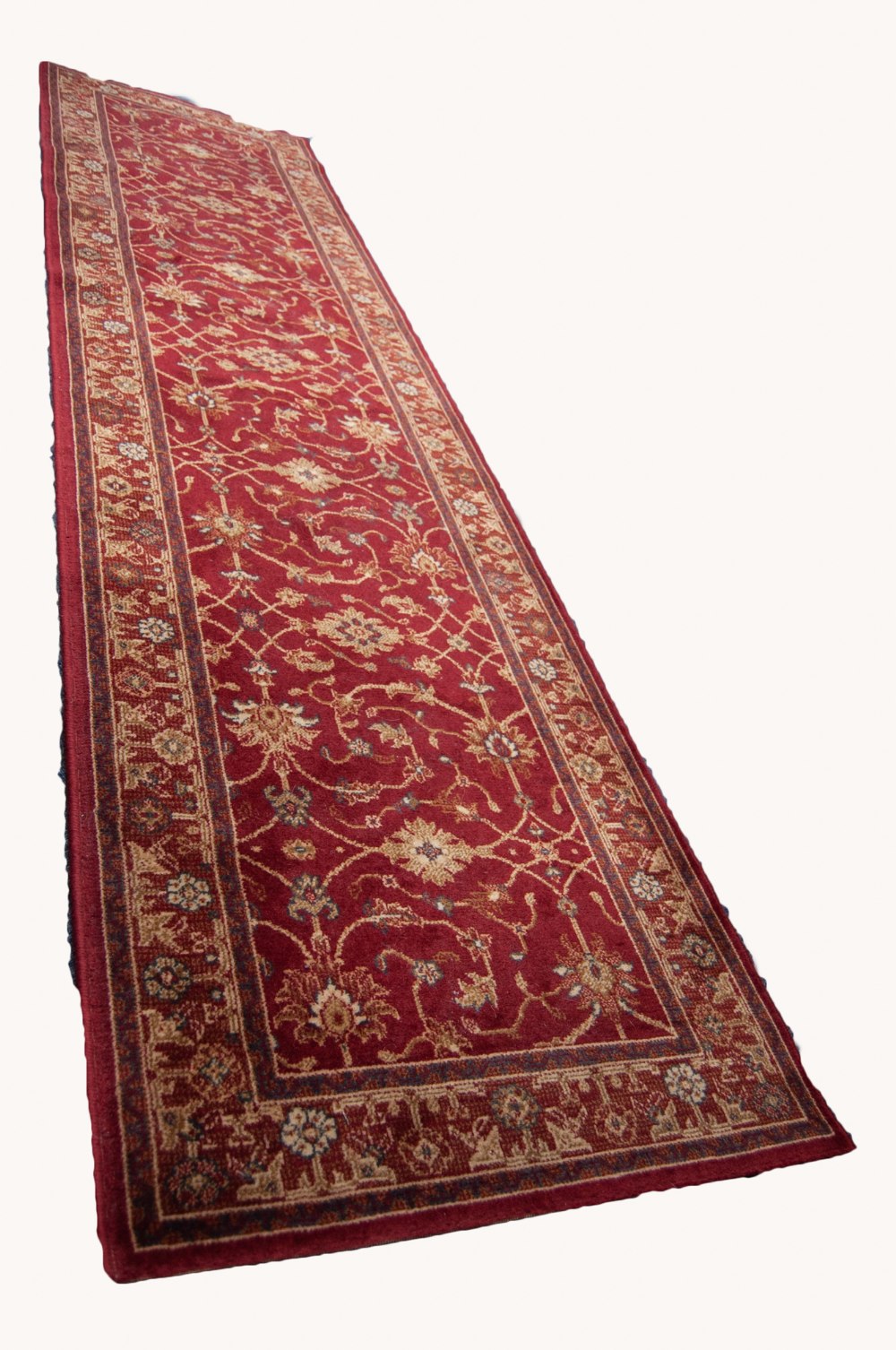 EUROPEAN MACHINE MADE BORDERED RUNNER, of Persian Herati design on a crimson field, 9'3" long, 2'