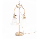 EARLY TWENTIETH CENTURY FRENCH BRASS TWIN LIGHT ADJUSTABLE TABLE LAMP, with scroll arms, moulded