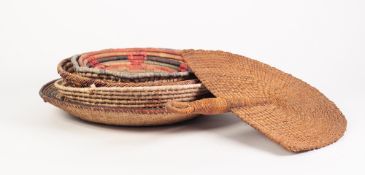 PROBABLY AFRICAN, FINELY WOVEN GRASS AND LEATHER SHALLOW BOWL, worked in colours with radiating