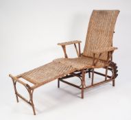 A BAMBOO AND RATAN RECLINING CONSERVATORY ARMCHAIR, with combined footstool