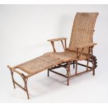 A BAMBOO AND RATAN RECLINING CONSERVATORY ARMCHAIR, with combined footstool