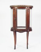 LATE NINETEENTH CENTURY MAHOGANY AND GILT METAL MOUNTED SMALL OVAL VITRINE, the top inset with an