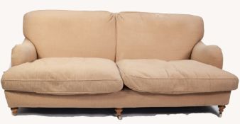 MODERN, FULLY UPHOLSTERED FOUR SEATER SETTEE with two loose cushions, on turned forelegs with